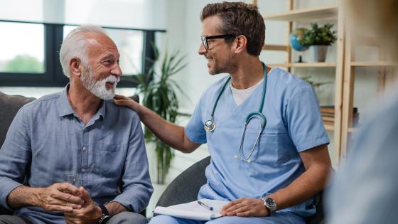 Stock image of a nurse speaking with an elderly patient